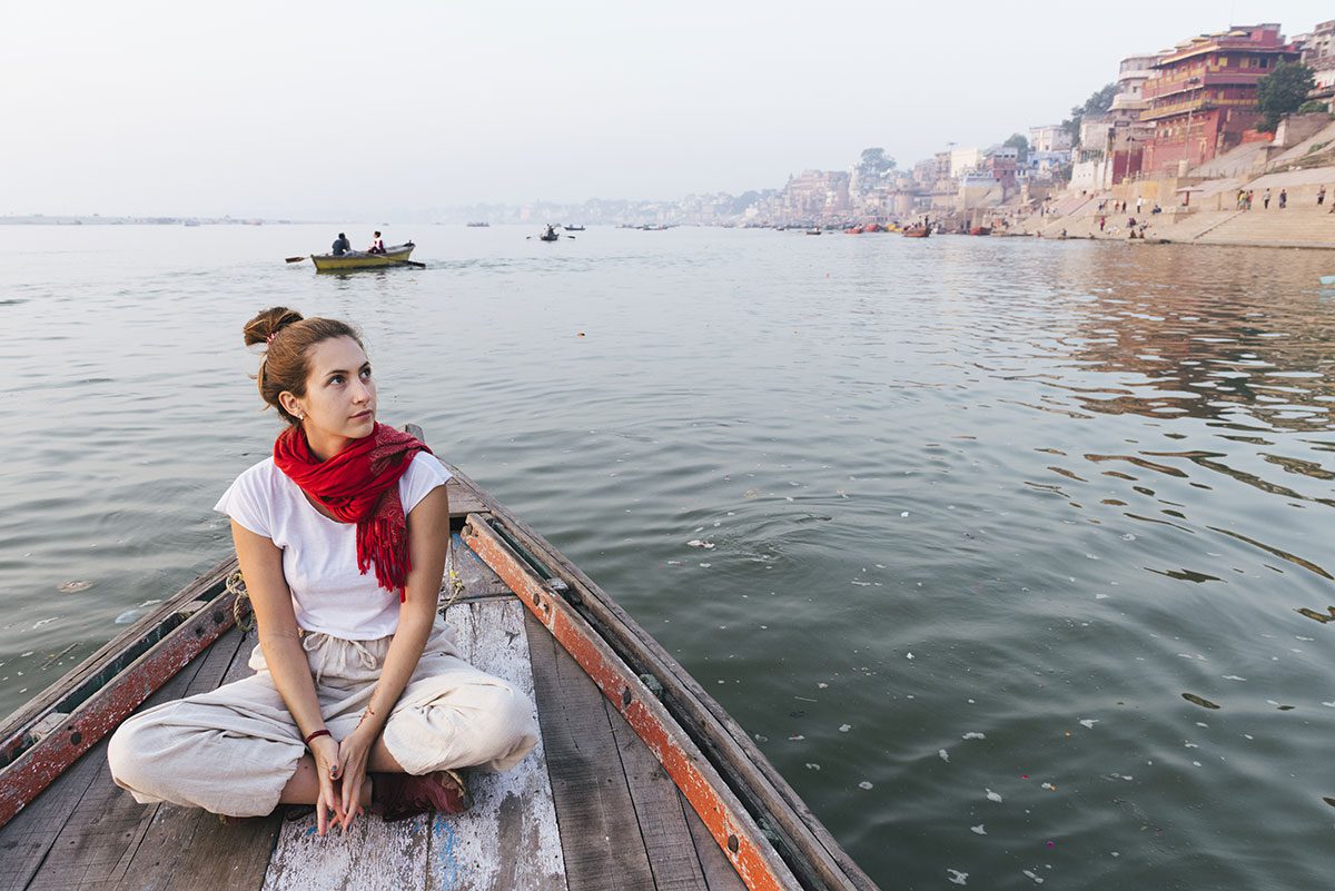Young woman on a boat on the Ganges river