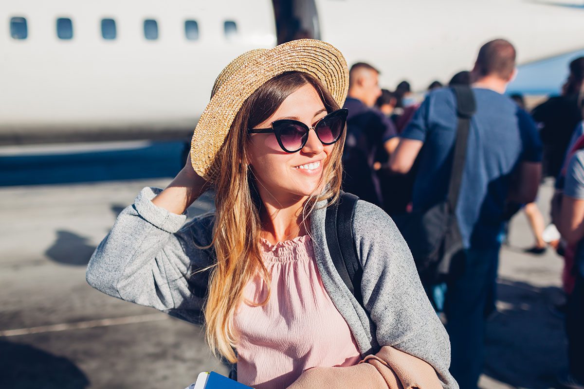 Smiling woman waiting to board plane