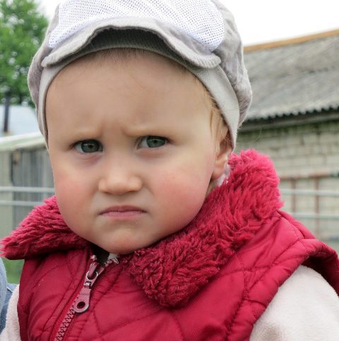 A young Russian girl with a scowl on her face