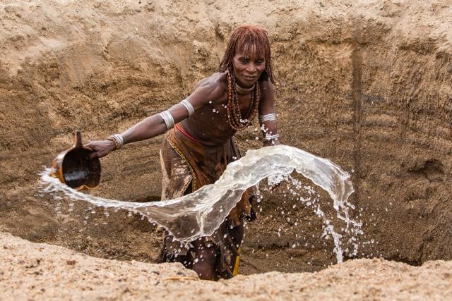 Tribal woman pouring water