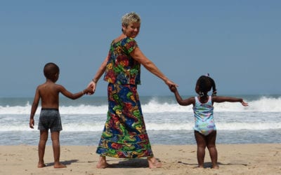 Granny Aupair on the beach with two children for the budget friendly travel page
