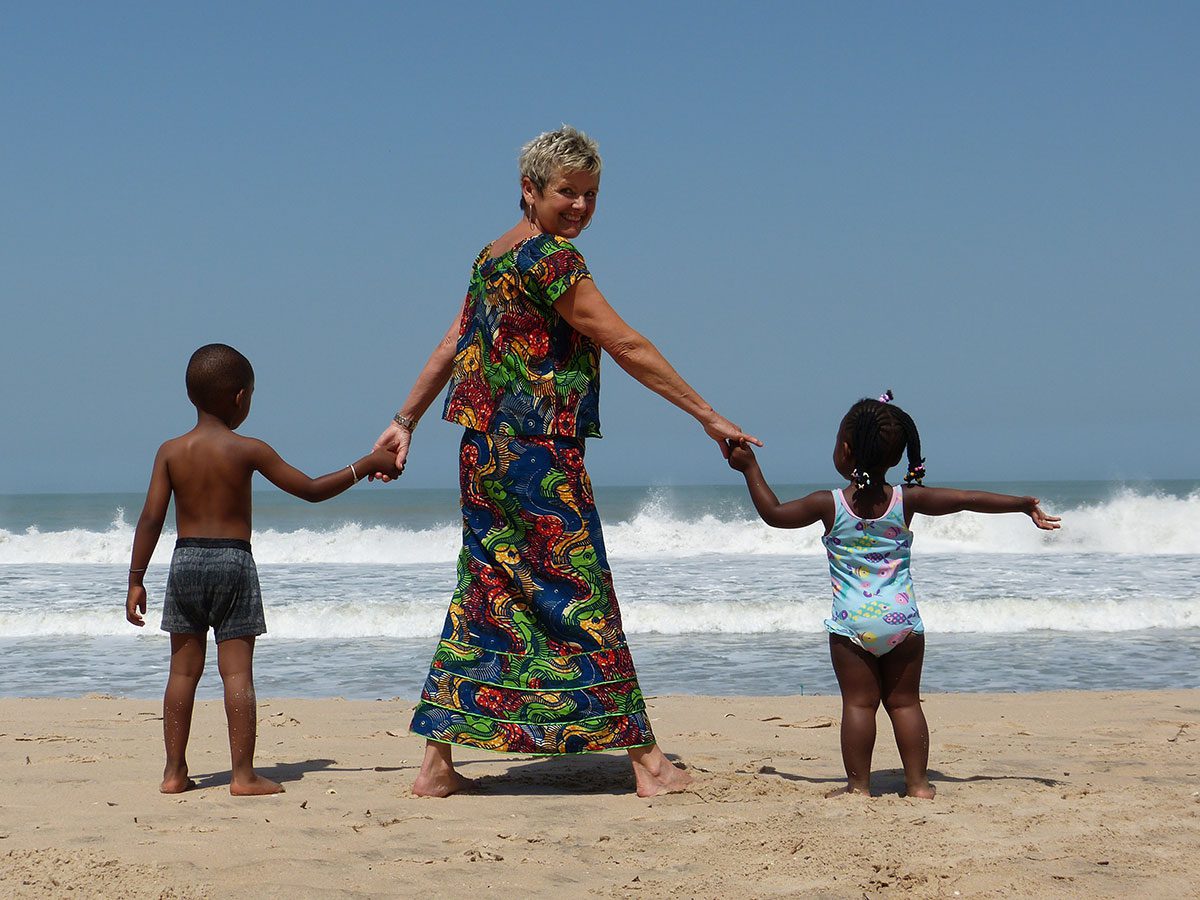 Granny Aupair on the beach with two children for the budget friendly travel page