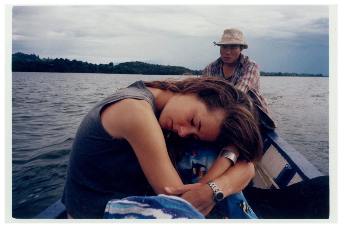 Hope rests her head on a boat with guide behind her