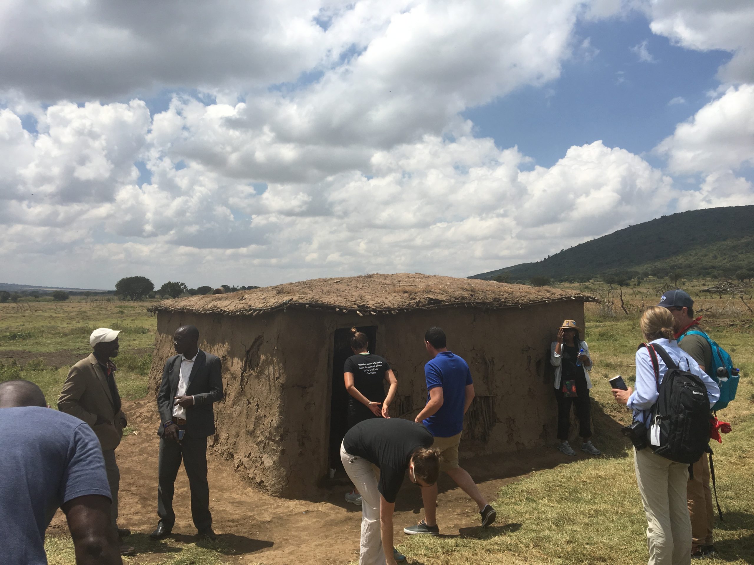 Visitors stand around a house