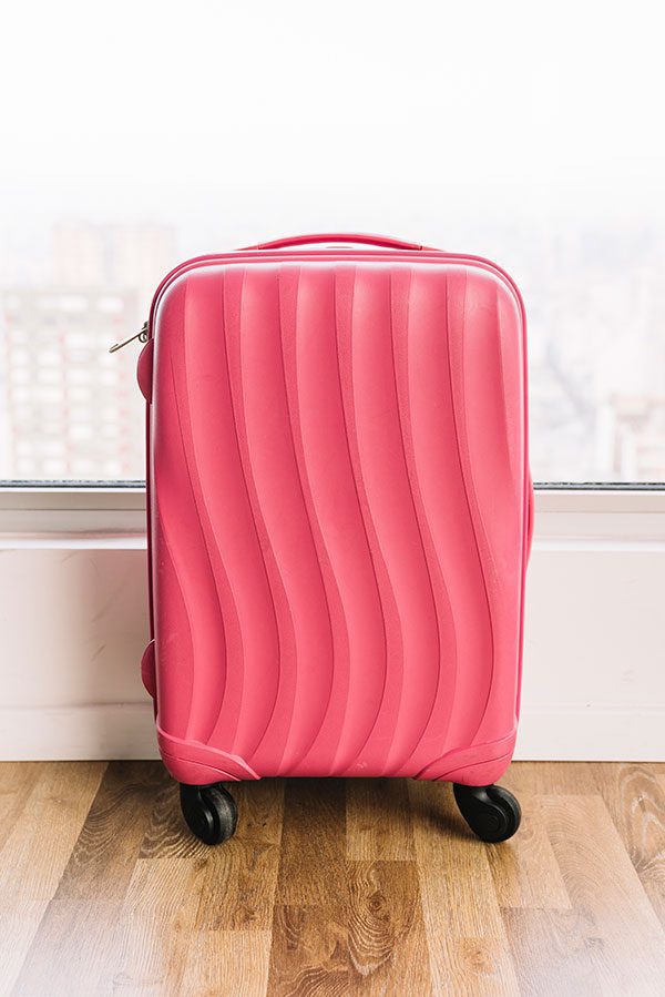 Pink suitcase with spinning wheels