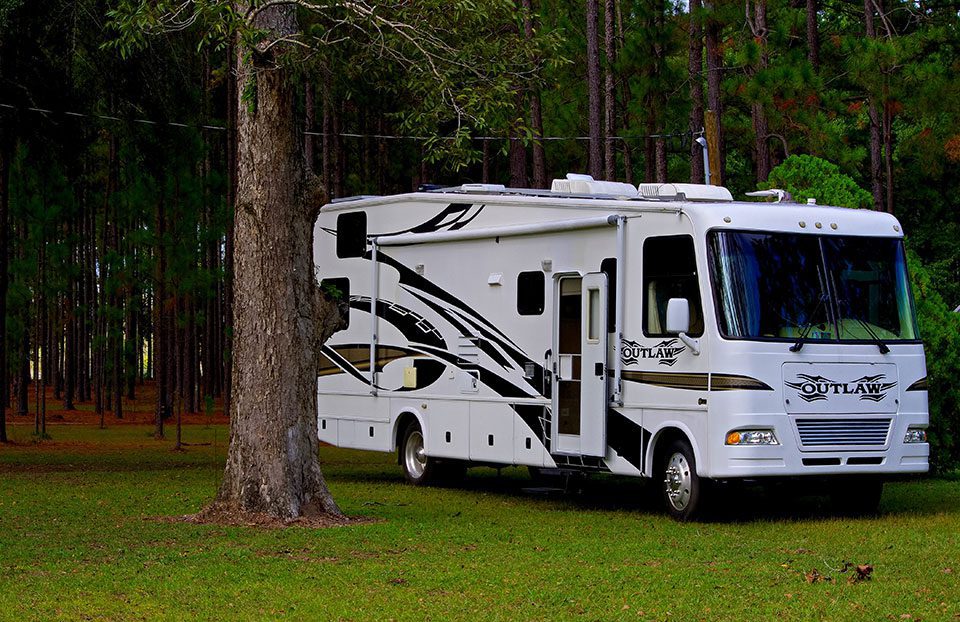 View of Outlaw RV in a copse of trees