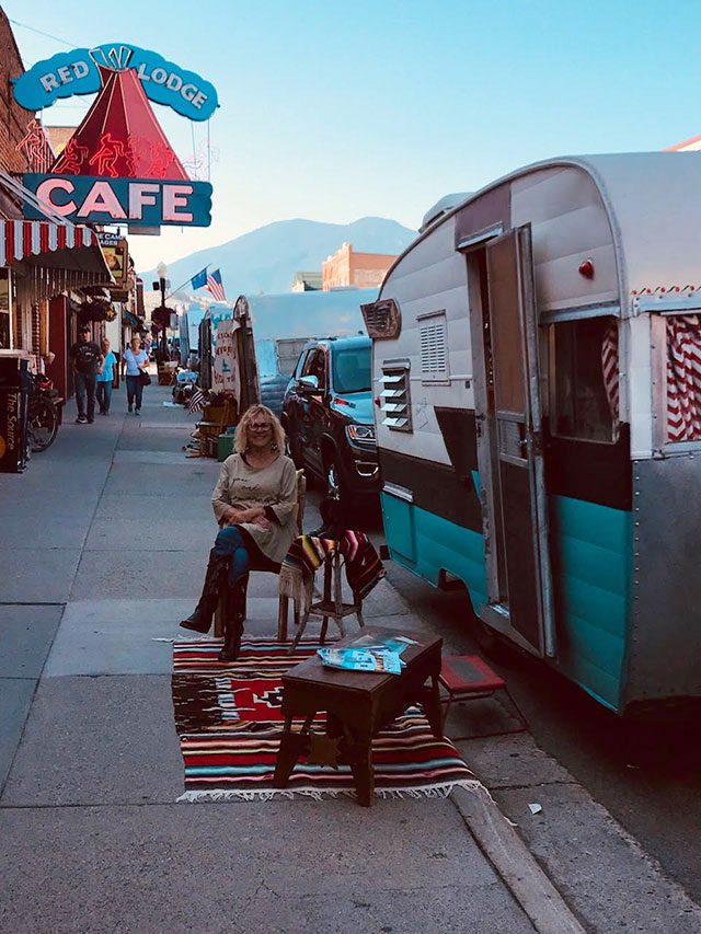 Maurie sits on the sidewalk outside her pride and joy, a 1947 Franklin RV