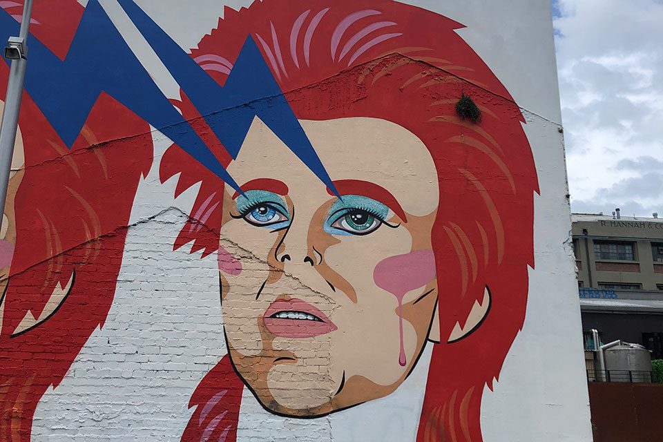 Painted wall mural of David Bowie as Ziggy Stardust in Wellington, New Zealand