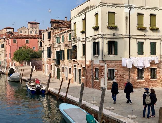 Tourists walking side streets in Venice, Italy