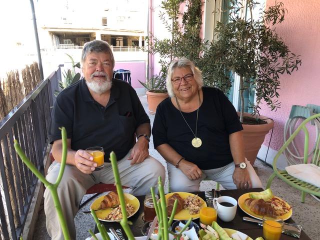 Sally and Rand Peabody at a table enjoying breakfast