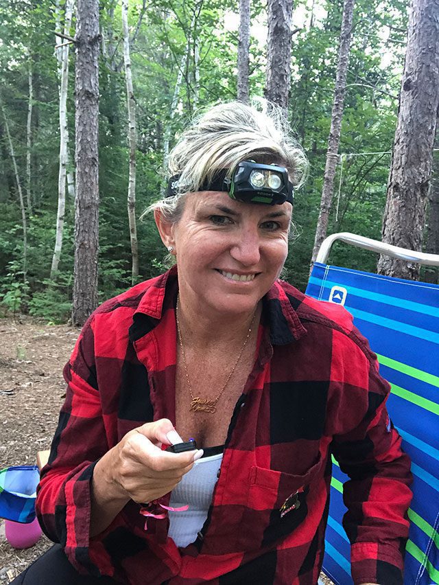 Carolyn takes a selfie with her headlamp