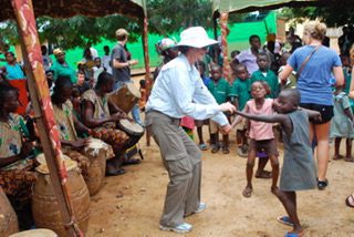 Marillee dancing with village children in Ghana