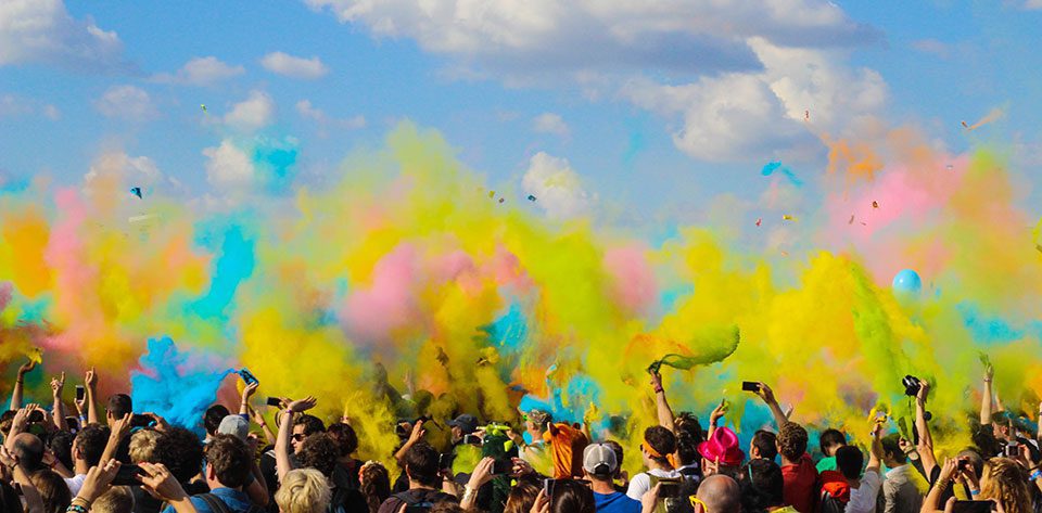 Bright colours thrown in the air at a music festival