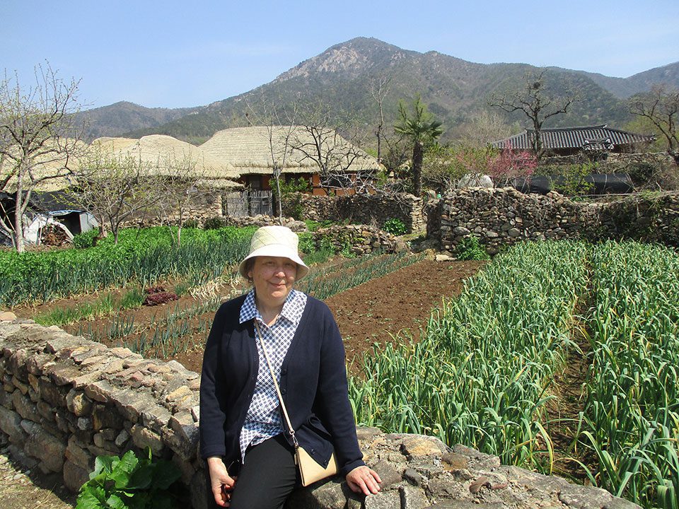 Karen sits on a wall outside a folk museum in Suchon South Korea