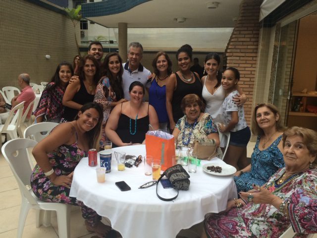 Happy people stand around a table