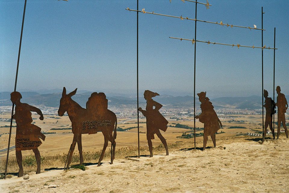 Statues of pilgrims on the Camino de Santiago trail