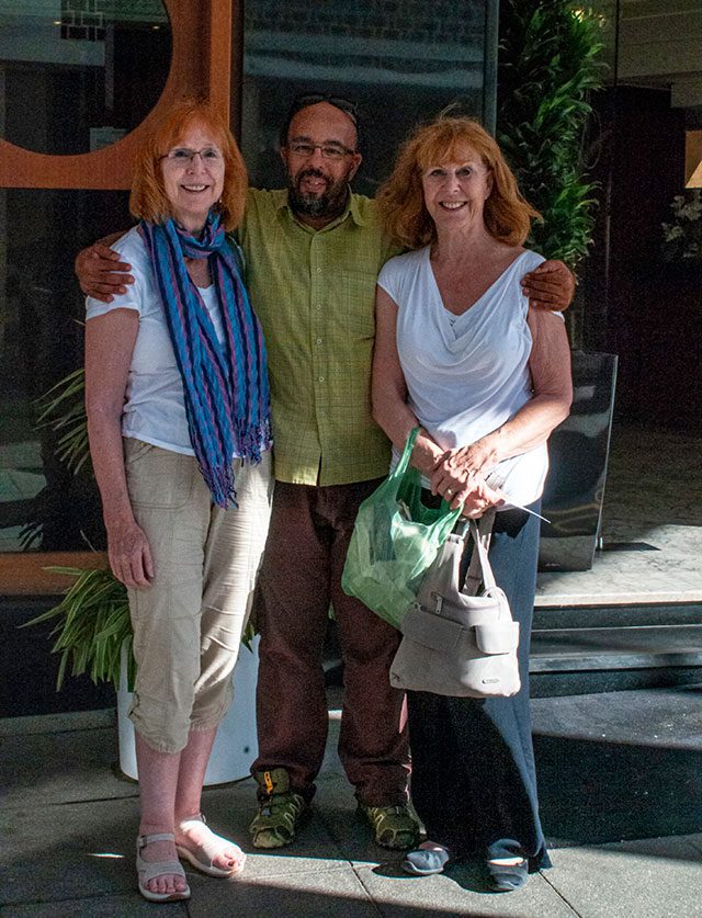 Diana and her sister stand with their driver Abdul