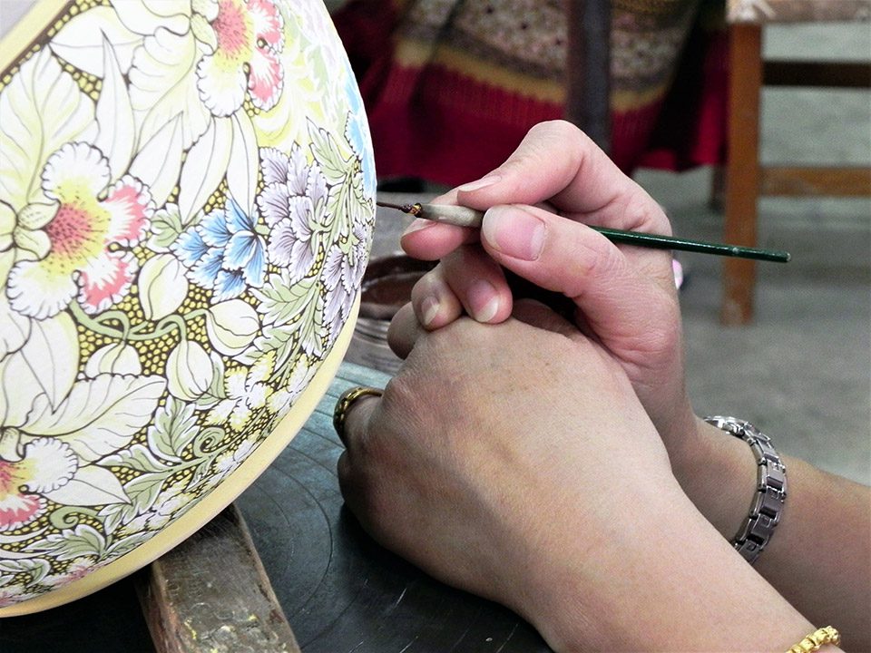 The author painting a piece of pottery