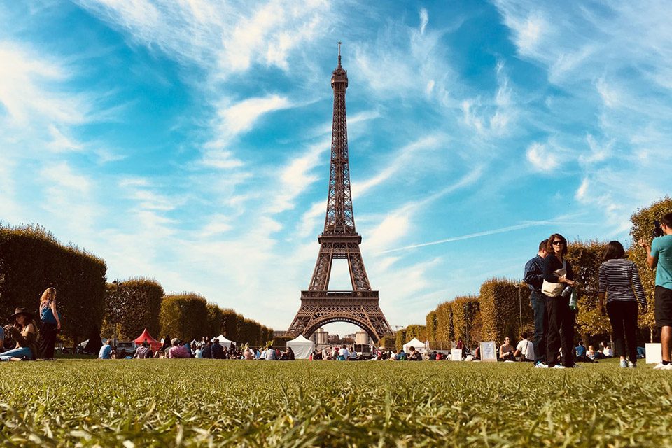 View of the Eiffel Tower in Paris from nearby field