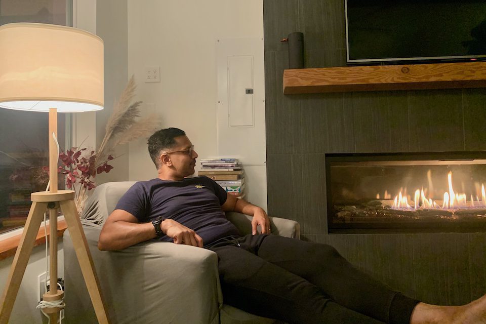 Danika's husband Myron relaxing by the epic wall-to-wall fireplace