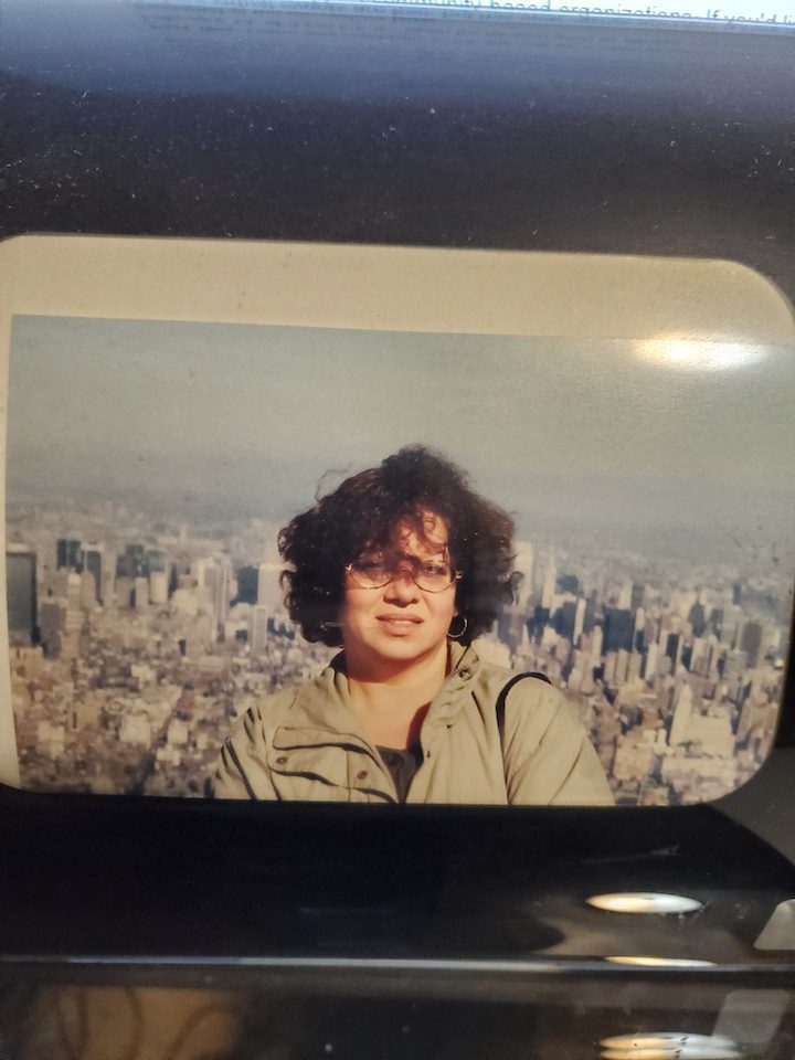 A portrait of Marion Broverman infront of a city skyline