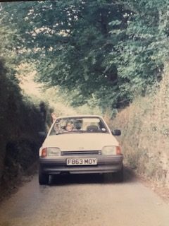 A car driving through a narrow road in the UK