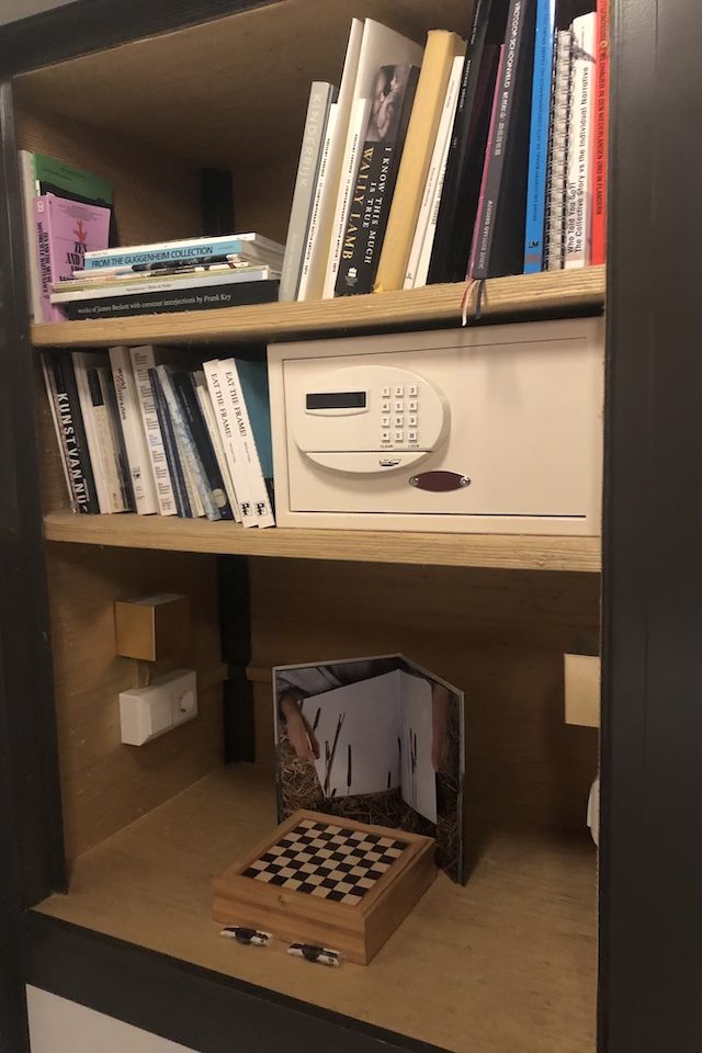 A safe and books on a book shelf