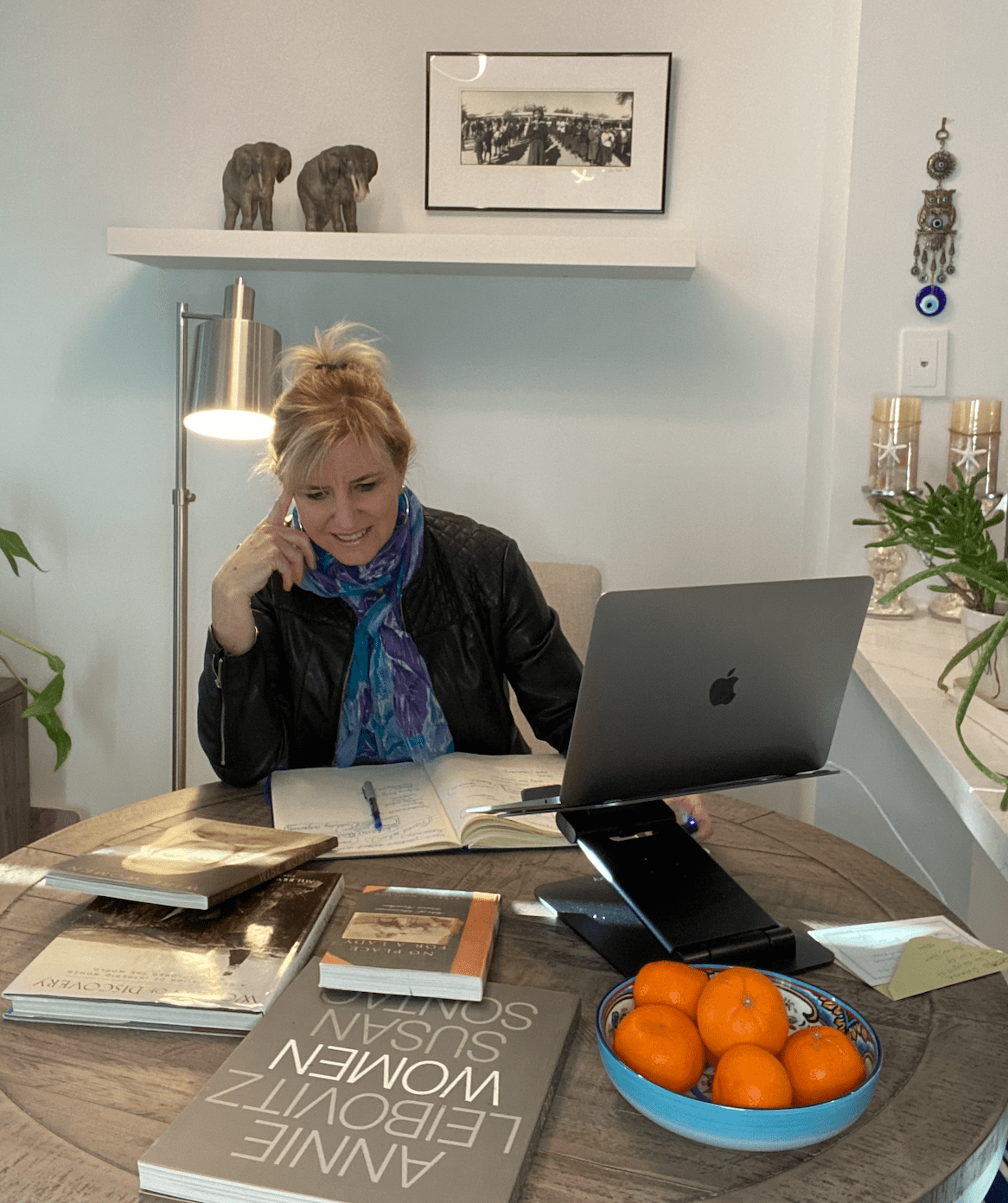 Carolyn Ray sitting at a table with some of Evelyn Hannon's old books