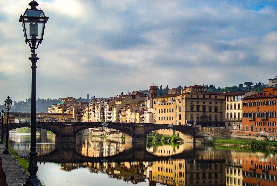 Buildings in Florence are reflected in the river