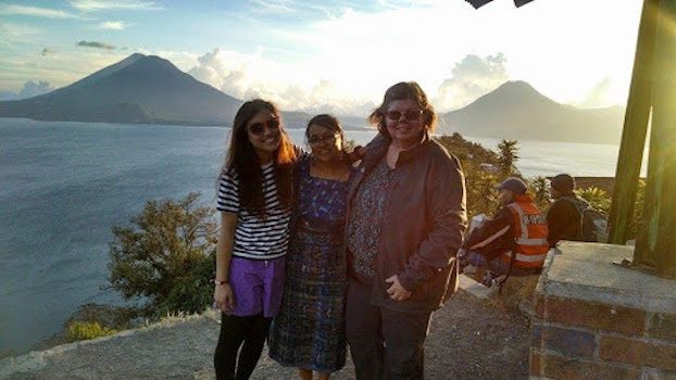 Three woman standing beside the sea in Guatemala