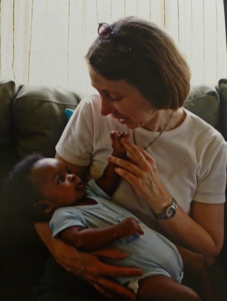 A woman holding her baby in her arms