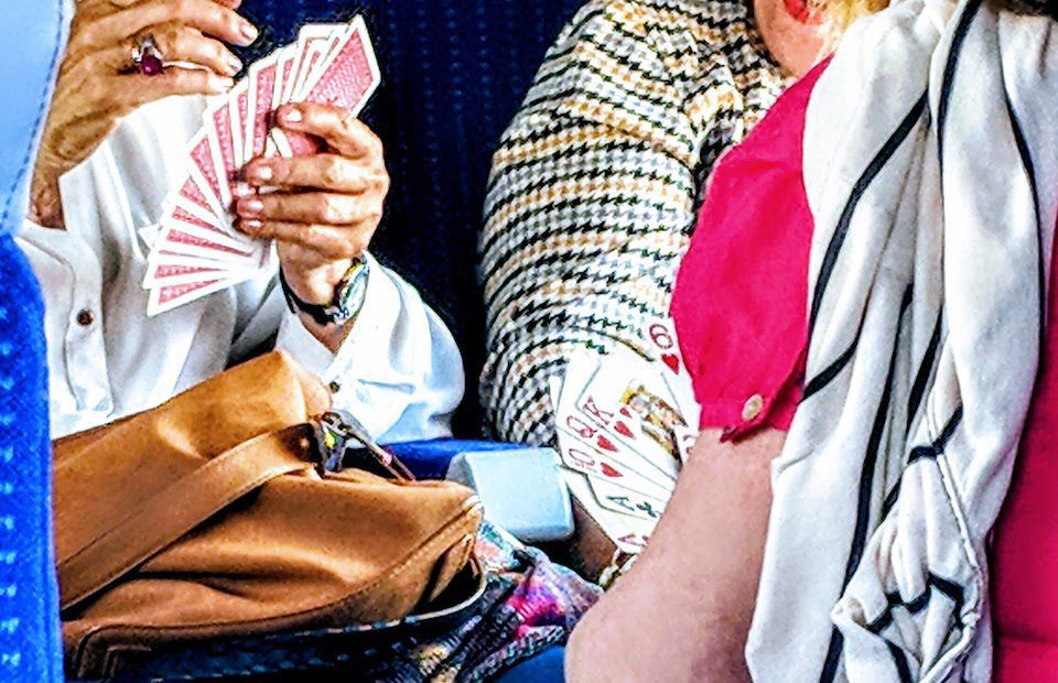 People playing cards on a train