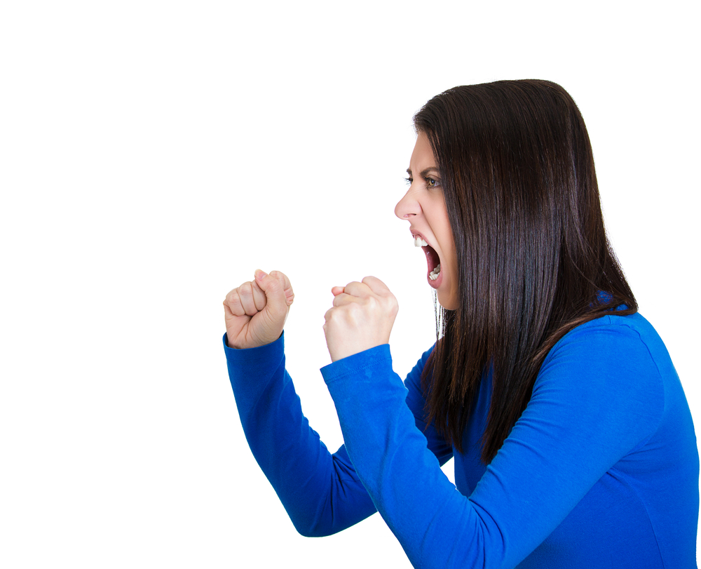 A woman holding up her fists, learning self-defense tips to stay safe.