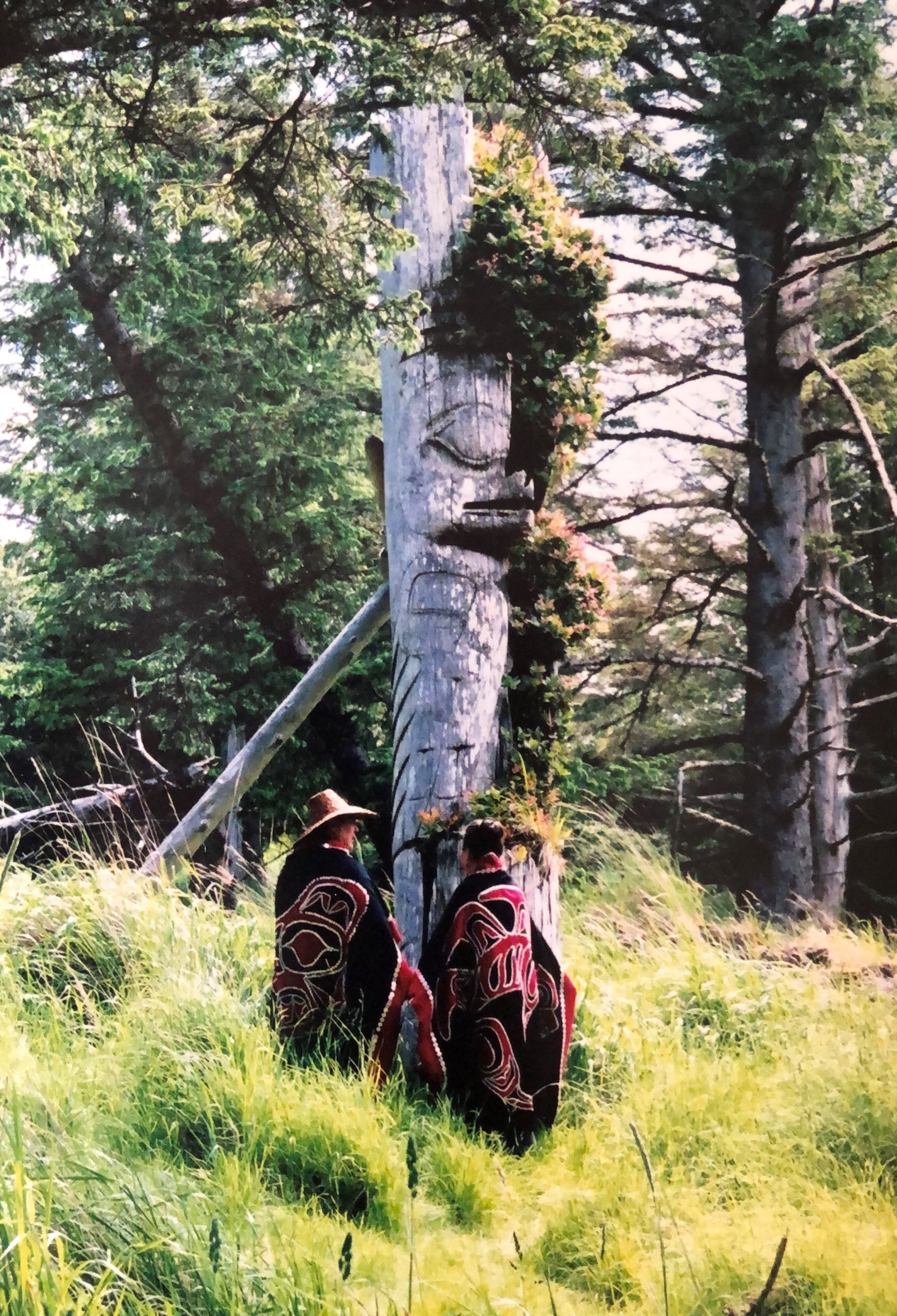 two men at totem pole