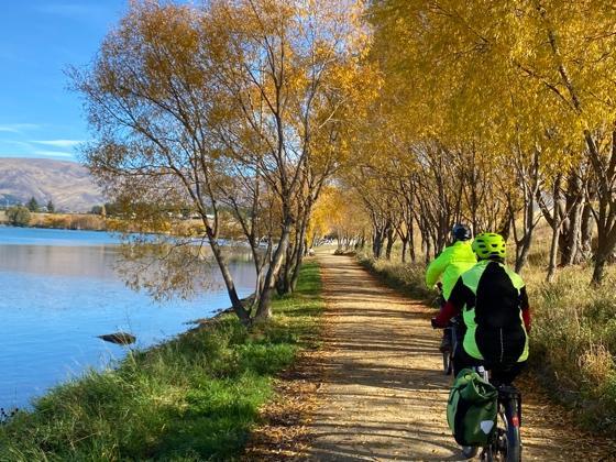 A person biking beside water in New Zealand