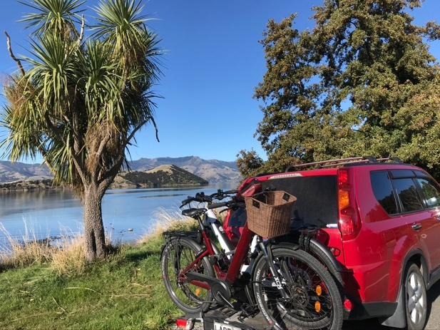 A red SUV with bikes on the back