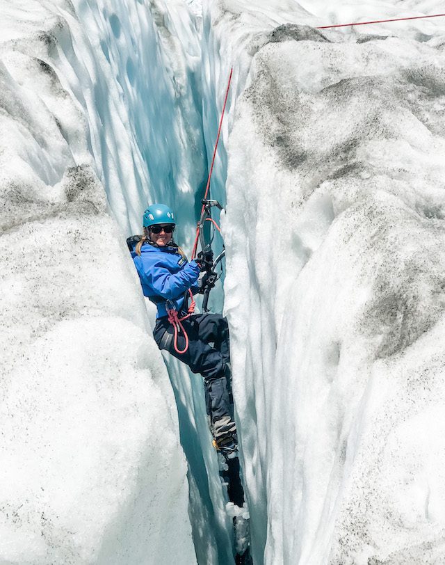 Amanda climbing out of a crevasse