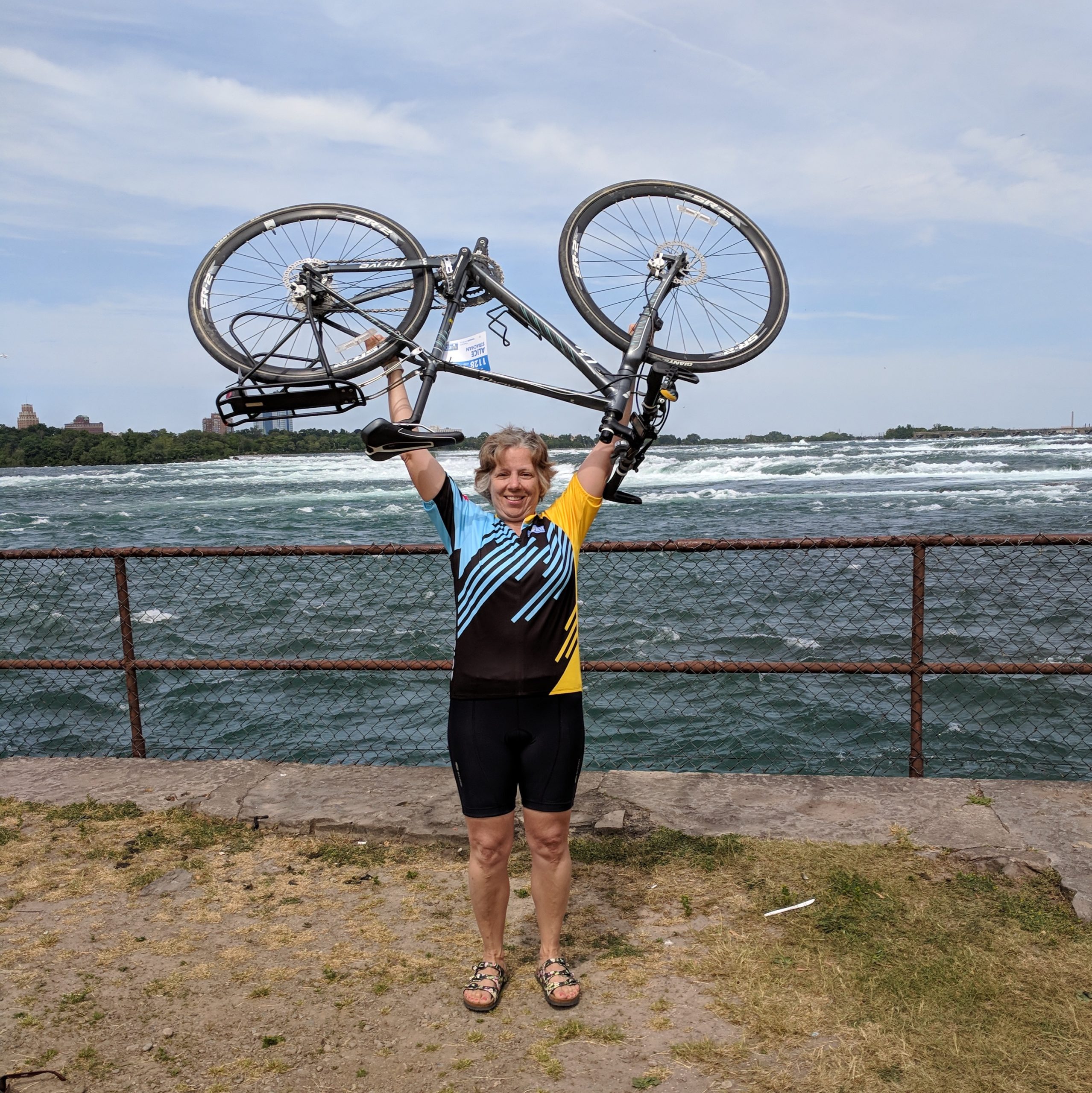 Alice Strachan strong-arming her bike at the close of the Ride to Conquer Cancer in Niagara Falls