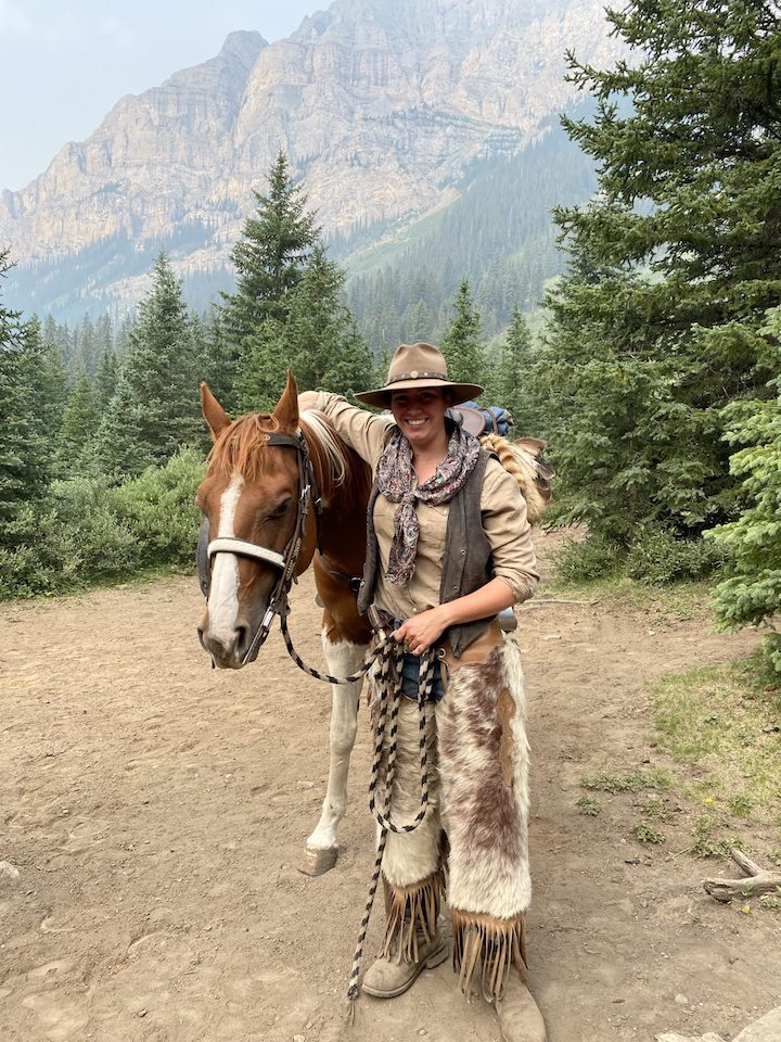 A woman wearing traditional horse riding gear in Banff