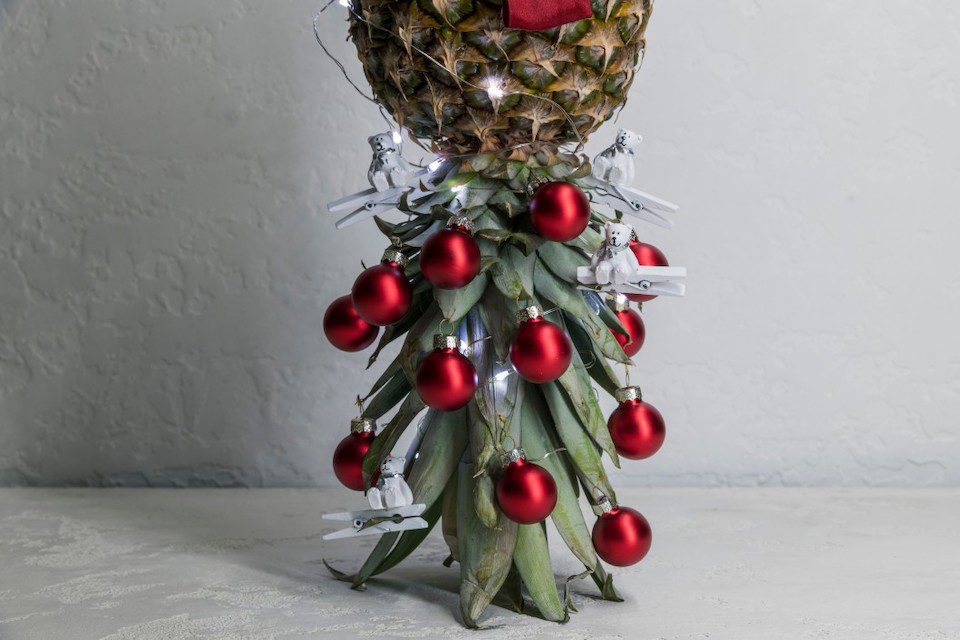 A pineapple decorated with Christmas ornaments