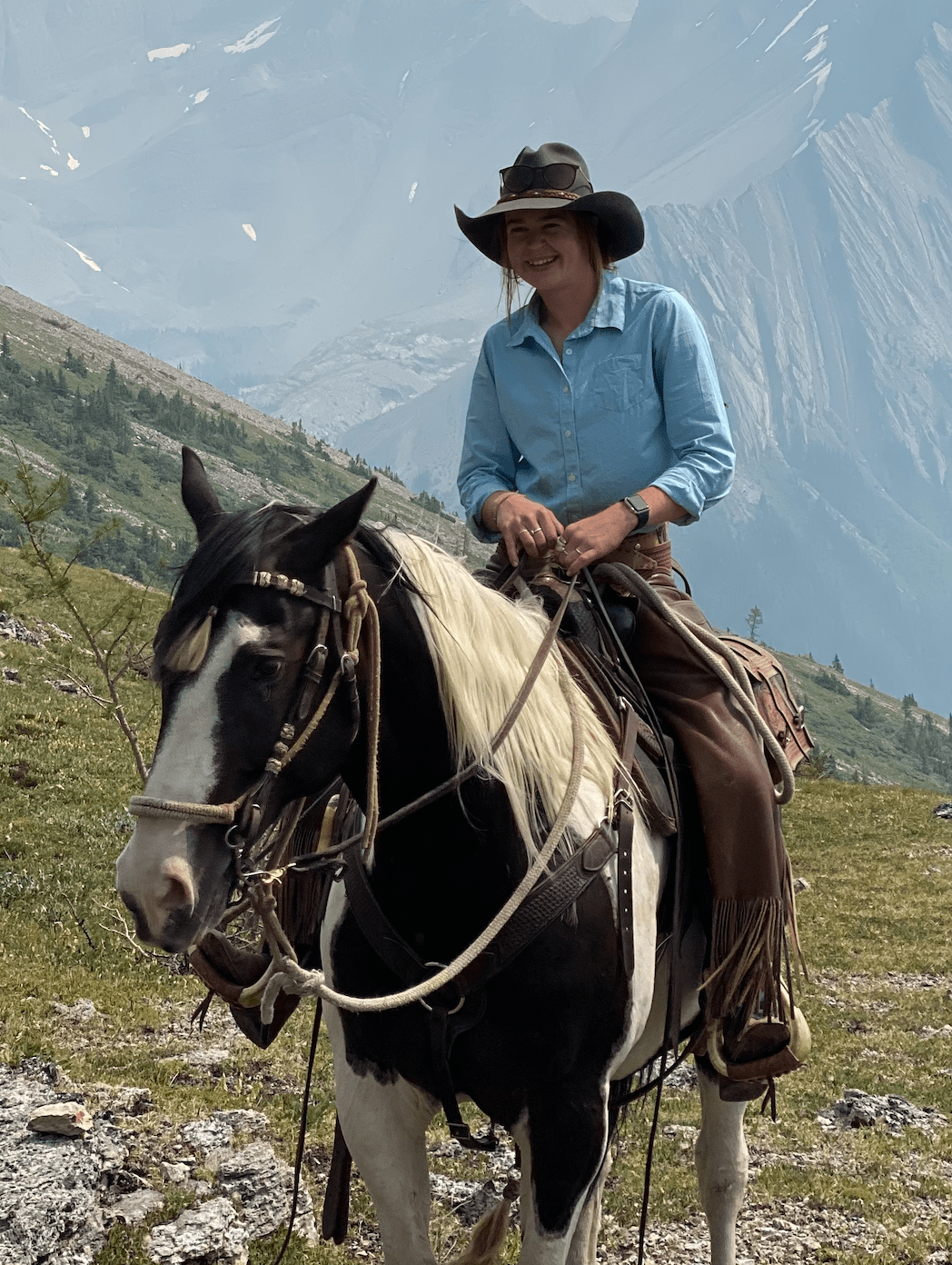 A woman riding a horse in the backcountry of the Canadian Rockies