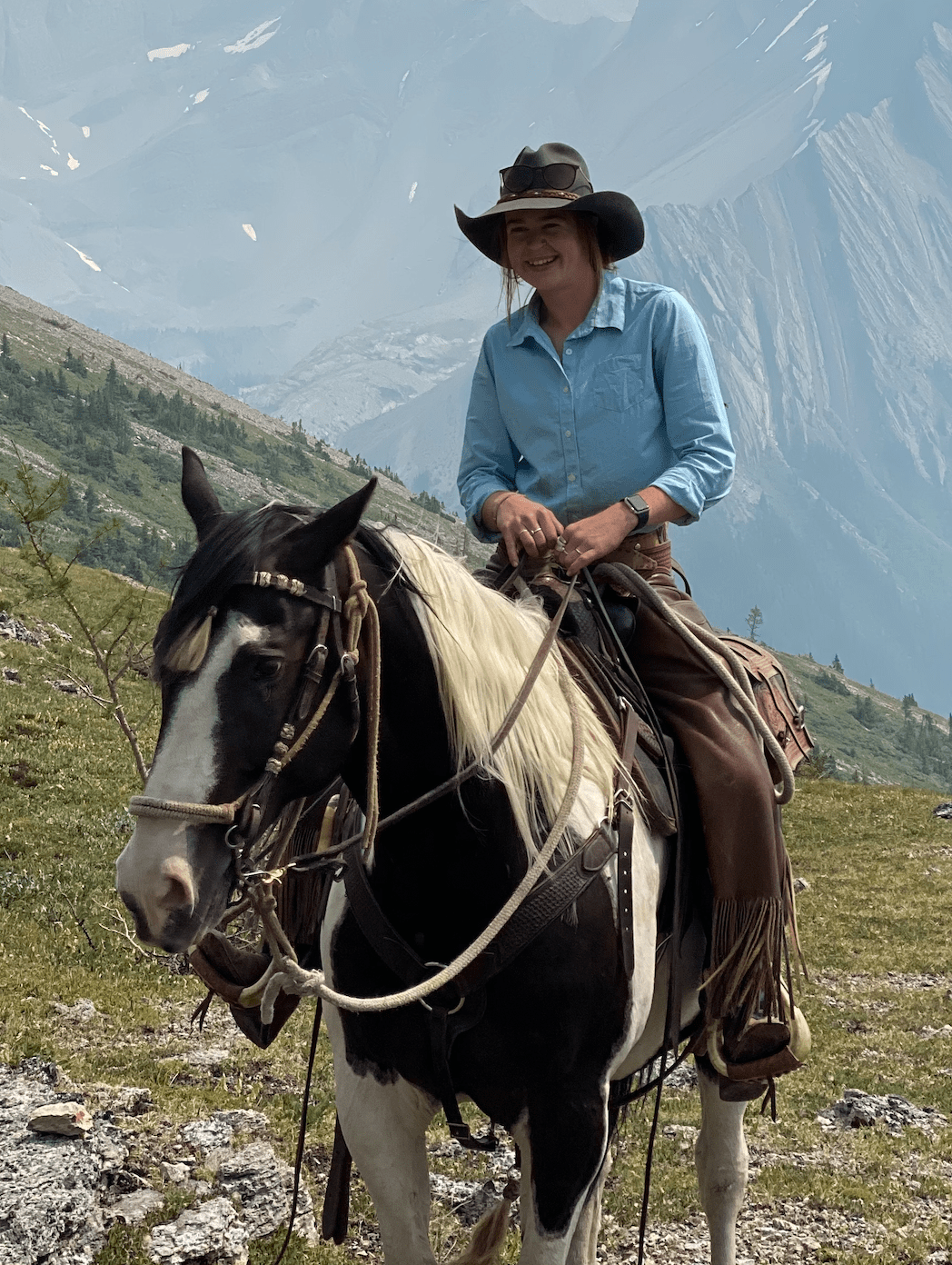 A young woman riding a horse, part of horse, front view in Banff