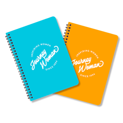 A blue and orange JourneyWoman notebook