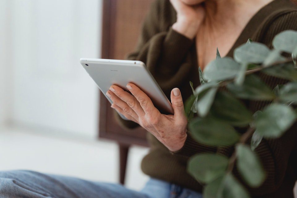 A woman researching travel ideas using an ipad