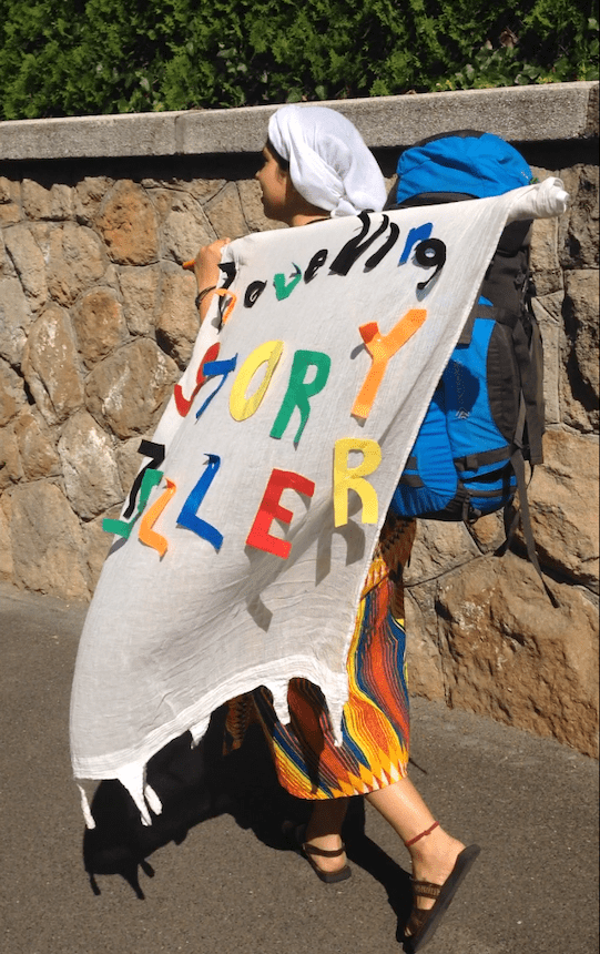 Juliana with her backpack and flag