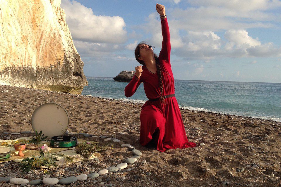 Juliana performing goddess stories and a ritual at Aphrodite’s beach, Paphos, Cyprus