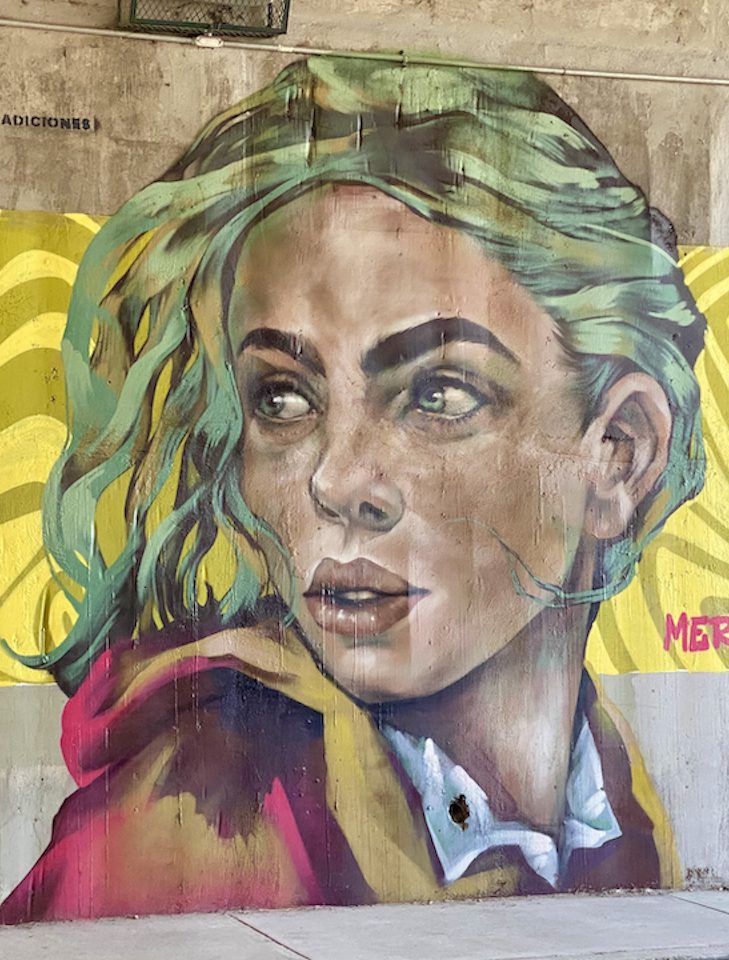 A street mural of a woman's face in San Miguel de Allende