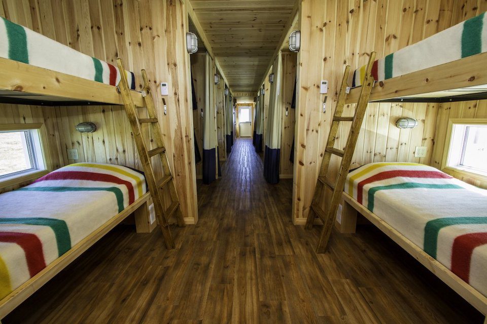 A wooden room with two bunk beds. These are the sleeping quarters in Tundra Lodge