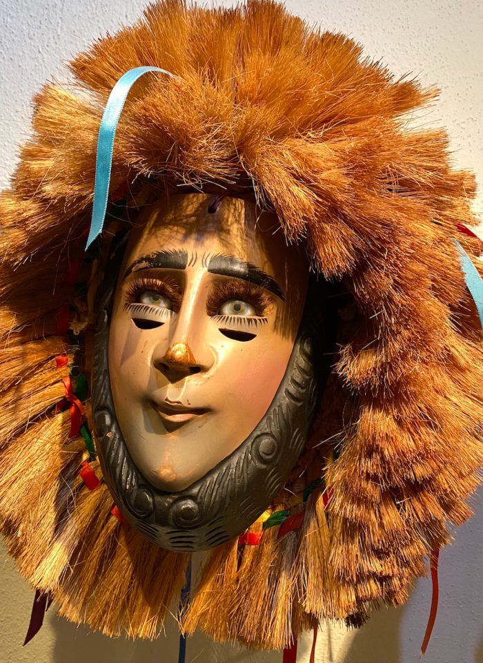 A mask of a woman with a mane of hair surrounding her face