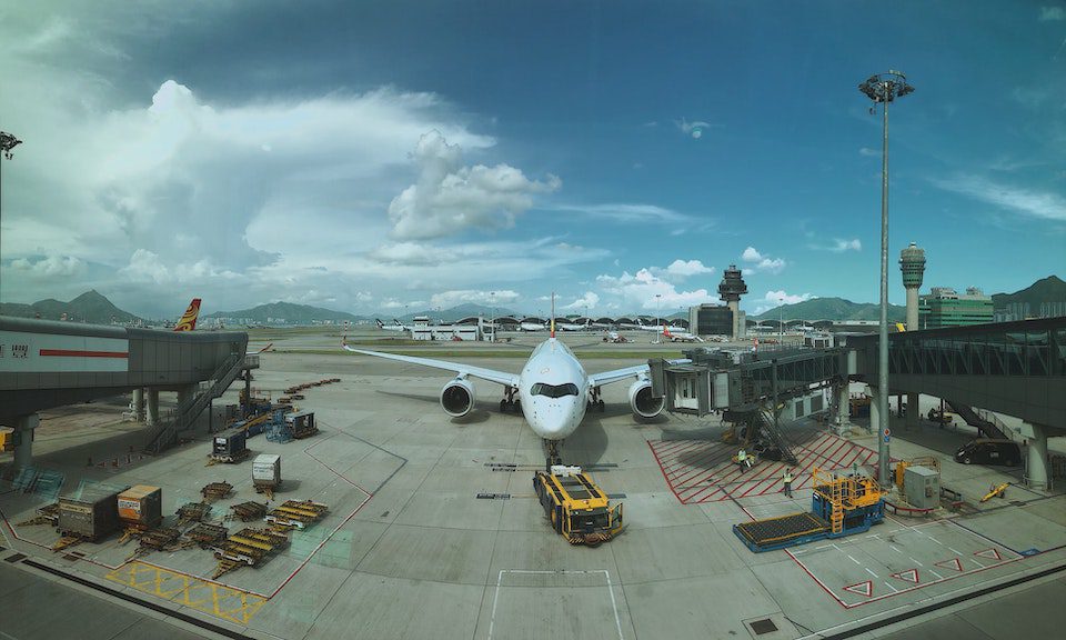 A large plane at a gate at Hong Kong International Airport